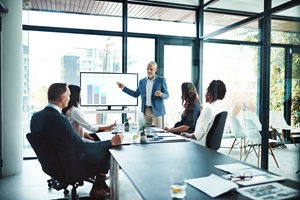 man giving presentation to other staff